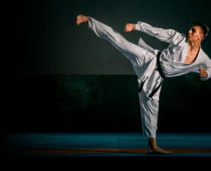 man doing a high karate kick