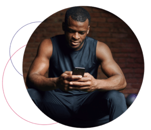 male looking at phone in fitness clothing