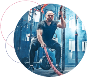 man working out with ropes in fitness center