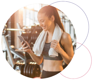 woman looking at mobile device in fitness club